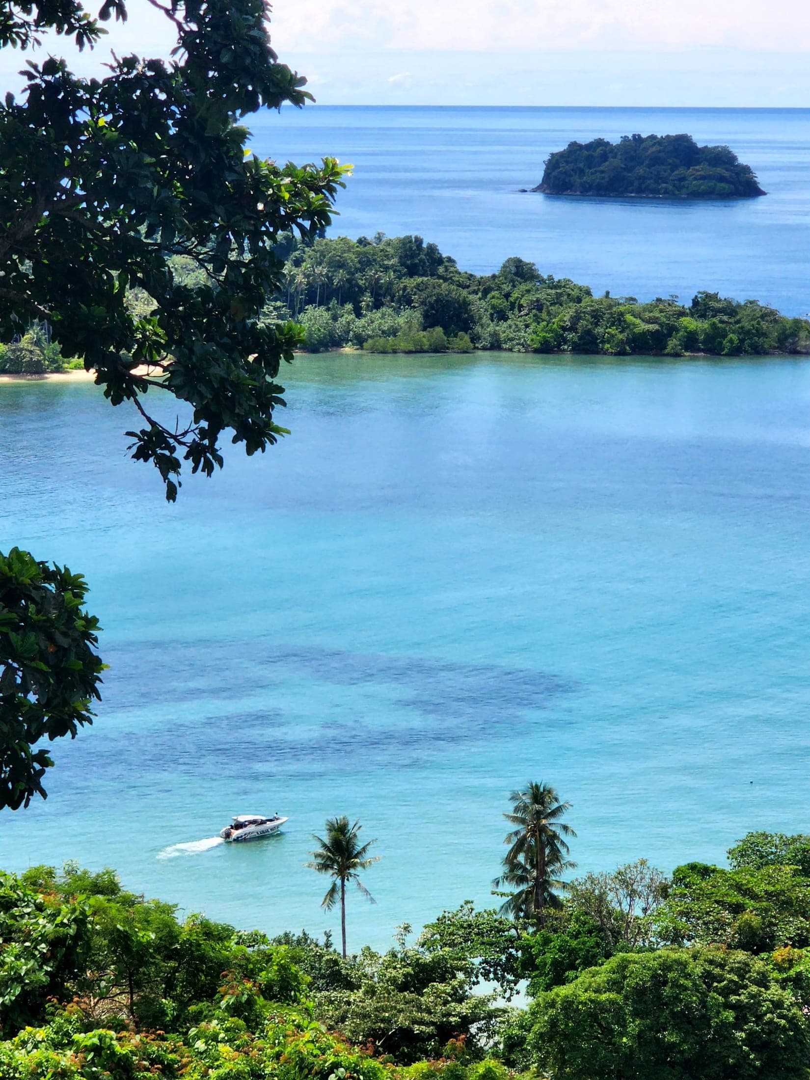 Turquoise bay framed by palm trees on Koh Chang