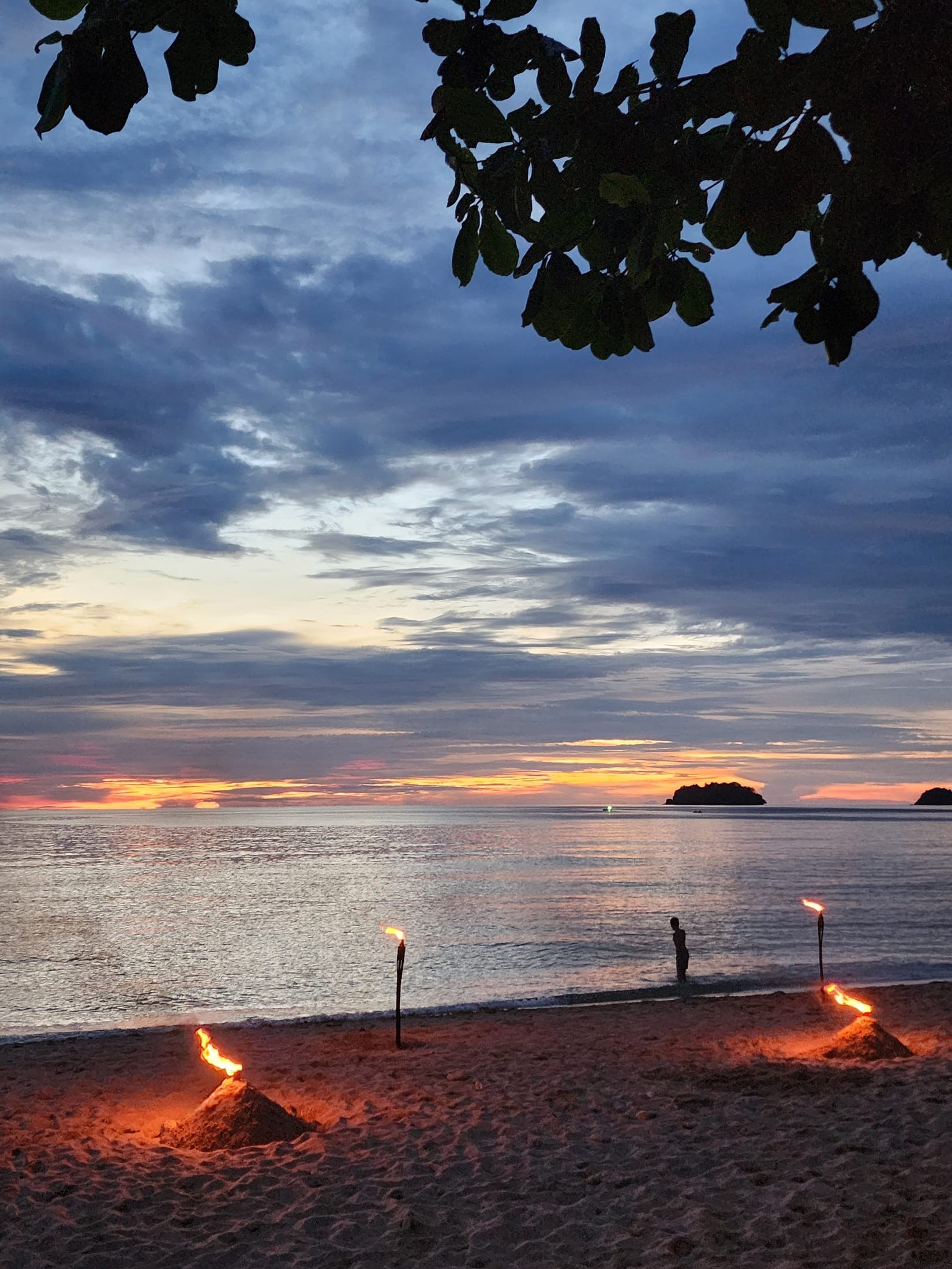 Sunset and fire torches on Lonely Beach, Koh Chang