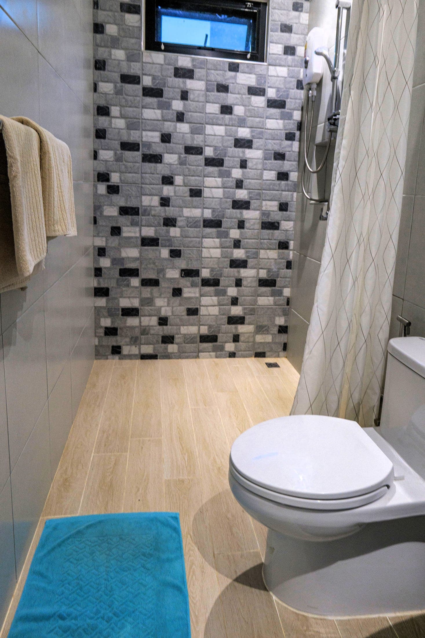 Bathroom of the second bungalow — mosaic-tiled walk-in shower