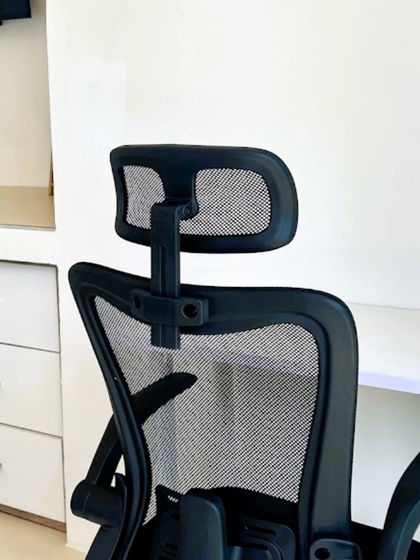 Modern Bungalow 1 — mesh office chair with a headrest at the white desk, drawers alongside