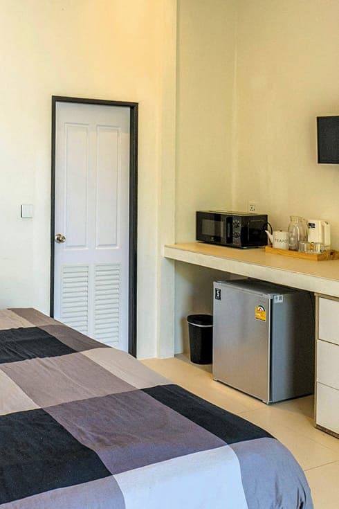Modern Bungalow 1 — kitchenette shelf with microwave, kettle and toaster over the fridge