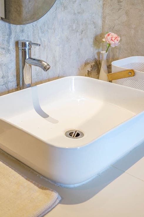 Modern Bungalow 1 — vessel basin against the polished concrete bathroom wall