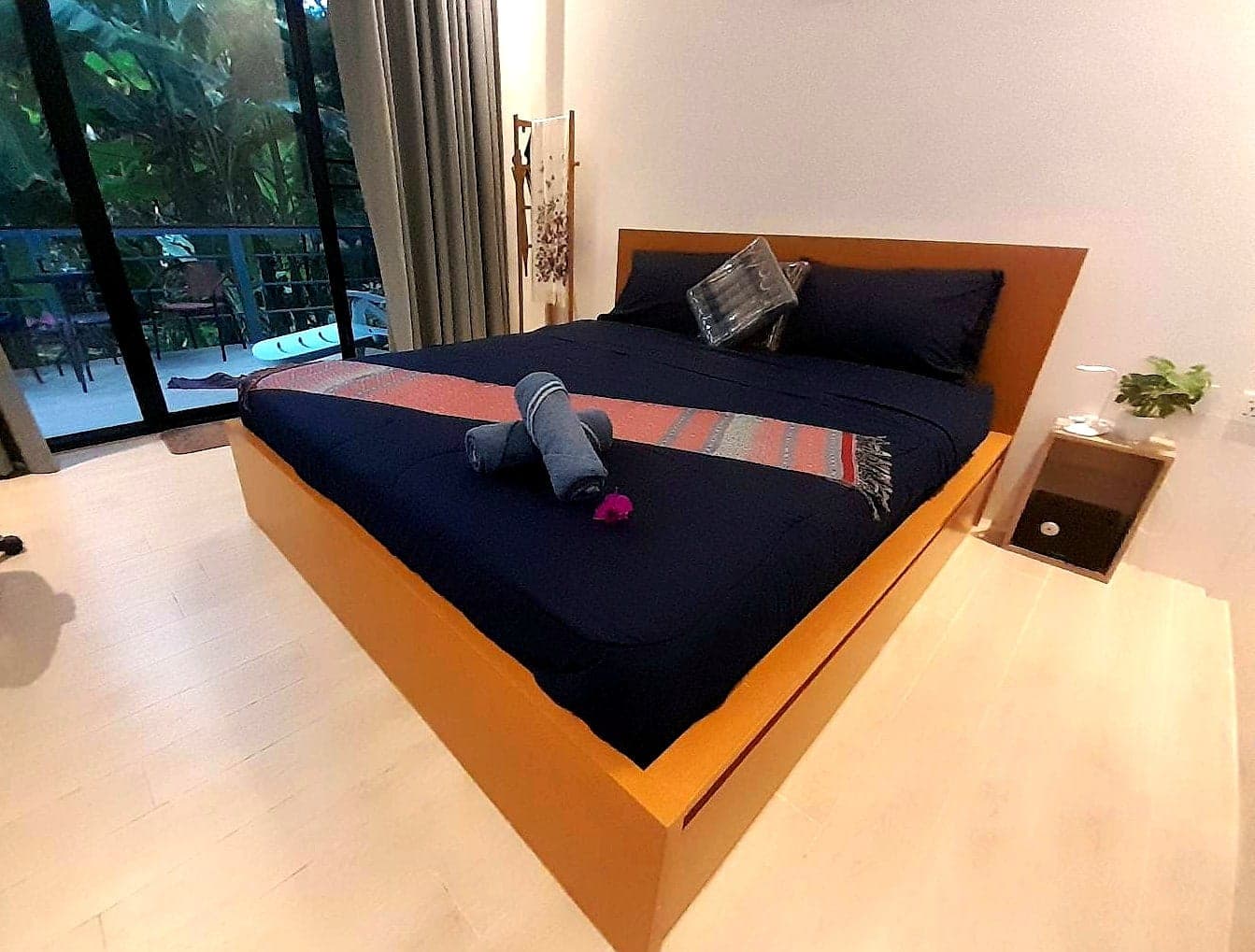 King-size bed facing the balcony doors and the jungle at Lonely Beach